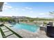 Gorgeous pool featuring travertine decking and stone waterfall feature at 20528 W Coolidge St, Buckeye, AZ 85396