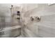 Close-up of the shower with gray tiling, built-in bench, and a shower head at 20528 W Coolidge St, Buckeye, AZ 85396