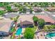 Beautiful aerial view of the home with a sparkling pool, spa, and lush landscaping in a desirable neighborhood at 2068 S Sailors Ct, Gilbert, AZ 85295