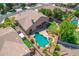 This aerial view showcases a backyard oasis with a pool, spa, well-maintained lawn, and mature trees at 2068 S Sailors Ct, Gilbert, AZ 85295