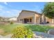 Home exterior showing covered back patio, pool with safety fence, and grassy area at 2068 S Sailors Ct, Gilbert, AZ 85295