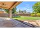Backyard featuring covered patio, grassy area, and desert landscaping at 2068 S Sailors Ct, Gilbert, AZ 85295