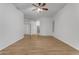 Bedroom featuring wood floors, ceiling fan, two doors and a view at 2068 S Sailors Ct, Gilbert, AZ 85295