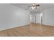 Bedroom featuring wood floors, ceiling fan, and two doors at 2068 S Sailors Ct, Gilbert, AZ 85295