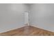Bedroom with wood flooring and white walls with view to hallway at 2068 S Sailors Ct, Gilbert, AZ 85295