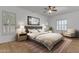 Beautiful main bedroom with neutral paint, area rug, window shutters and ceiling fan at 2068 S Sailors Ct, Gilbert, AZ 85295