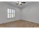 Bedroom with wood floors, ceiling fan, and shuttered windows at 2068 S Sailors Ct, Gilbert, AZ 85295