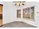 Bright dining area with tile floors, white walls, window shutters and a ceiling fan with light fixture at 2068 S Sailors Ct, Gilbert, AZ 85295