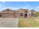 A charming single-story home with a three-car garage, landscaped lawn, and stone accents at 2068 S Sailors Ct, Gilbert, AZ 85295