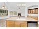 A kitchen island with a sink offers a view into a living space and fireplace at 2068 S Sailors Ct, Gilbert, AZ 85295