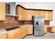 A kitchen features stainless steel appliances, wood cabinets and modern backsplash at 2068 S Sailors Ct, Gilbert, AZ 85295