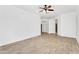 Open-concept living room with tile floors, white walls, arched doorways and natural light at 2068 S Sailors Ct, Gilbert, AZ 85295