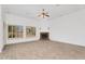 Spacious living room with tile floors, white walls, window shutters and stone fireplace at 2068 S Sailors Ct, Gilbert, AZ 85295