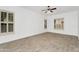 Bright, open living room with tile floors, white walls, neutral window shutters and ceiling fan at 2068 S Sailors Ct, Gilbert, AZ 85295