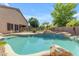 Relaxing pool and spa featuring rock waterfalls and a well-maintained yard at 2068 S Sailors Ct, Gilbert, AZ 85295