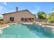 Inviting backyard pool with rock features, spa, and lush landscaping offers a serene retreat at 2068 S Sailors Ct, Gilbert, AZ 85295