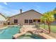 Inviting backyard pool with rock features, spa, and lush landscaping offers a serene retreat at 2068 S Sailors Ct, Gilbert, AZ 85295