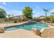 Backyard pool with rock details, spa, and landscaping creates a private oasis at 2068 S Sailors Ct, Gilbert, AZ 85295