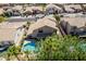 Aerial view of a home featuring a backyard pool surrounded by mature trees in a well-maintained neighborhood at 2108 E Tecoma Rd, Phoenix, AZ 85048