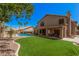 This manicured backyard offers artificial turf, a gated pool area, and a covered patio for outdoor living at 2108 E Tecoma Rd, Phoenix, AZ 85048