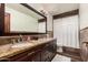 Elegant bathroom featuring dual sinks with granite countertop and decorative tile at 2108 E Tecoma Rd, Phoenix, AZ 85048