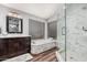 Bathroom featuring double sinks, tiled shower, and tub at 2108 E Tecoma Rd, Phoenix, AZ 85048