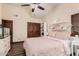Charming bedroom featuring a ceiling fan, a large closet, and light pink themed decor at 2108 E Tecoma Rd, Phoenix, AZ 85048
