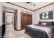Bedroom featuring wood trim, sports decor, and stairs to a basement level at 2108 E Tecoma Rd, Phoenix, AZ 85048