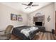 Cozy bedroom with a ceiling fan, a window with wooden blinds and music themed decorations at 2108 E Tecoma Rd, Phoenix, AZ 85048