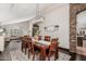 Dining area featuring a farmhouse-style table, modern lighting, and a stone accent wall at 2108 E Tecoma Rd, Phoenix, AZ 85048
