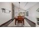 Dining area featuring a wooden table, modern lighting, a stone pillar, and hardwood floors at 2108 E Tecoma Rd, Phoenix, AZ 85048
