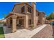 Stunning home exterior featuring a covered patio, lush landscaping, and a charming walkway to the backyard oasis at 2108 E Tecoma Rd, Phoenix, AZ 85048