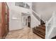 Grand foyer with a staircase, tile flooring, and a view of the living spaces at 2108 E Tecoma Rd, Phoenix, AZ 85048
