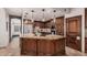 Gourmet kitchen with stainless steel appliances, custom cabinets, granite countertops and a center island with bar seating at 2108 E Tecoma Rd, Phoenix, AZ 85048