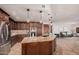 Open concept kitchen with stainless steel appliances, custom cabinets, granite countertops and a center island with seating at 2108 E Tecoma Rd, Phoenix, AZ 85048