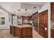 Gourmet kitchen with stainless steel appliances, custom cabinets, granite countertops and a center island with bar seating at 2108 E Tecoma Rd, Phoenix, AZ 85048