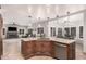 Open concept kitchen with stainless steel appliances, granite countertops and a center island with seating overlooking the living room at 2108 E Tecoma Rd, Phoenix, AZ 85048