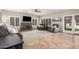 Bright living room featuring a stone fireplace, tiled floors, and access to the backyard through glass paneled doors at 2108 E Tecoma Rd, Phoenix, AZ 85048