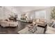 Bright and airy living room showcasing stylish decor, wood floors, and a dining area at 2108 E Tecoma Rd, Phoenix, AZ 85048