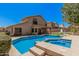 Inviting pool area features a built-in spa, stone accents, and a spacious deck for outdoor entertaining at 2108 E Tecoma Rd, Phoenix, AZ 85048
