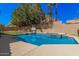 Sparkling pool with baja step and integrated spa, surrounded by a spacious deck, perfect for summer relaxation at 2108 E Tecoma Rd, Phoenix, AZ 85048
