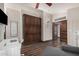 Bright room featuring a closet, desk, comfortable sofa and wood floors at 2108 E Tecoma Rd, Phoenix, AZ 85048