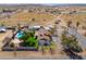 Aerial view displaying this charming home with a refreshing pool and covered parking, and a desert landscape at 2151 S Calle Del Marcos --, Casa Grande, AZ 85194