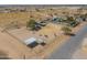 Aerial view displays property with horses, shelters, and a fenced area, set against a desert backdrop at 2151 S Calle Del Marcos --, Casa Grande, AZ 85194