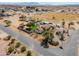 Wide aerial view displays home, horse property, shelters, pool, desert landscape and neighborhood setting at 2151 S Calle Del Marcos --, Casa Grande, AZ 85194