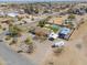 Aerial view showcasing this charming home with a refreshing pool and covered parking, nestled in a desert landscape at 2151 S Calle Del Marcos --, Casa Grande, AZ 85194