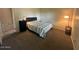 Simple bedroom with a neutral color scheme, carpet, and a bed with striped bedding, offering a serene space at 2151 S Calle Del Marcos --, Casa Grande, AZ 85194