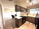 Functional kitchen featuring brown cabinetry, tile floors, and an adjacent dining area with lots of natural light at 2151 S Calle Del Marcos --, Casa Grande, AZ 85194