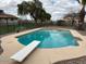 View of a fenced pool with a diving board, featuring clear blue water and trees in the background at 2151 S Calle Del Marcos --, Casa Grande, AZ 85194