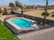 Aerial view of backyard featuring a fenced in pool with a diving board, set in brick pavers and gravel at 2151 S Calle Del Marcos --, Casa Grande, AZ 85194